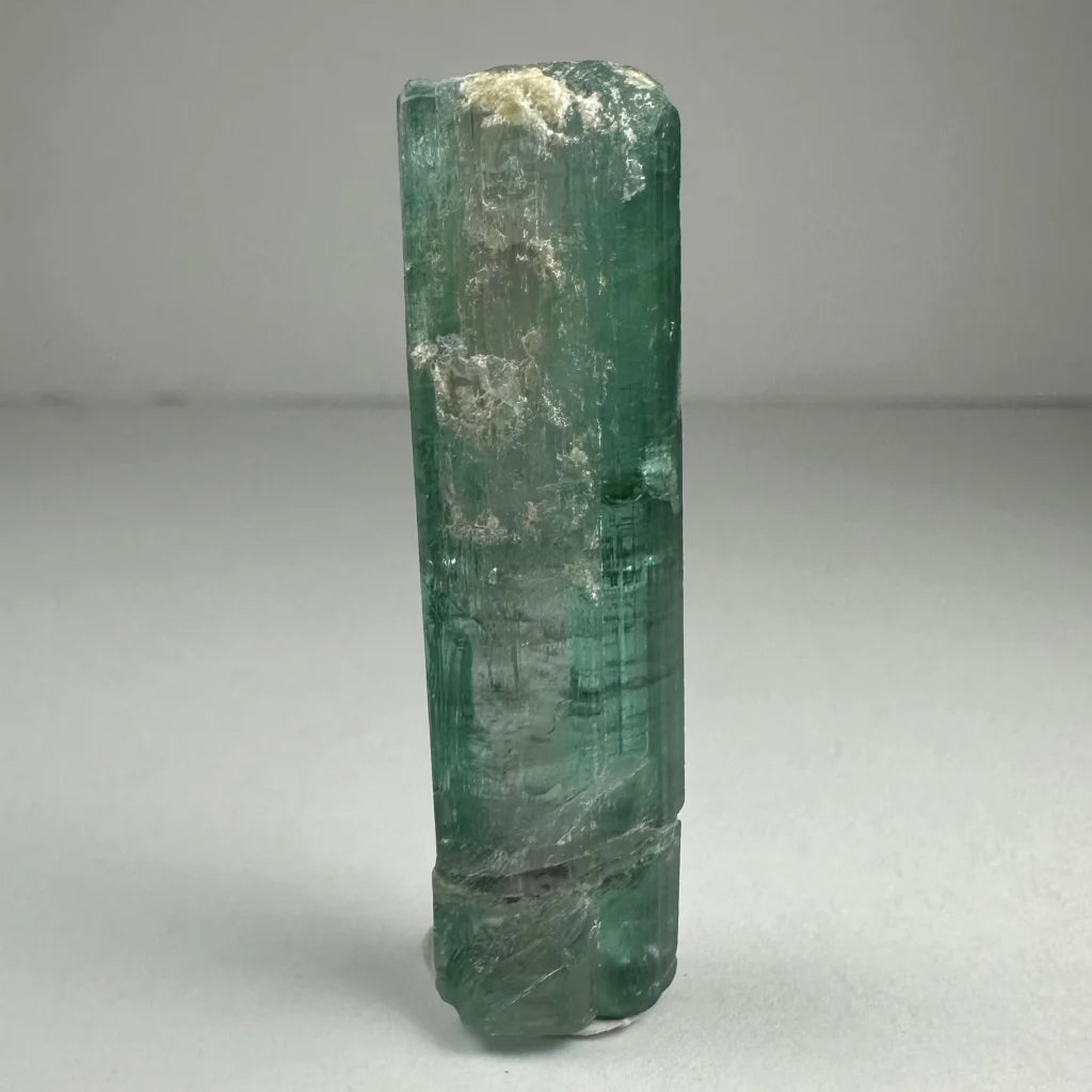 Natural indicolite tourmaline emerald green crystal with striations