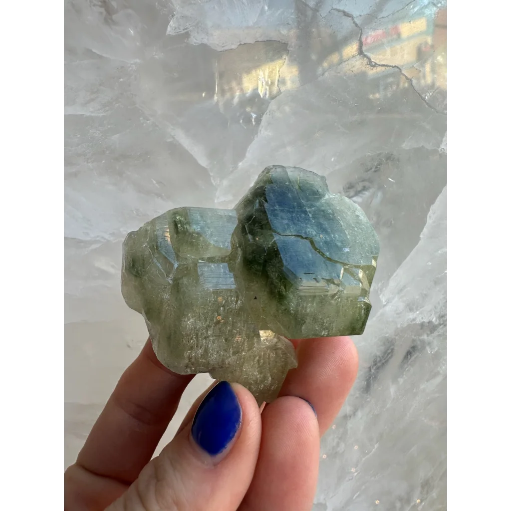Translucent green fluorapatite cluster with crystalline facets and inclusions