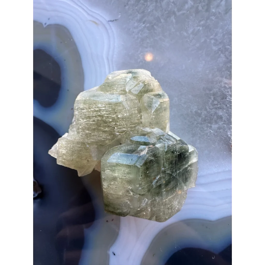 Natural green fluorapatite cluster with translucent crystals and striations