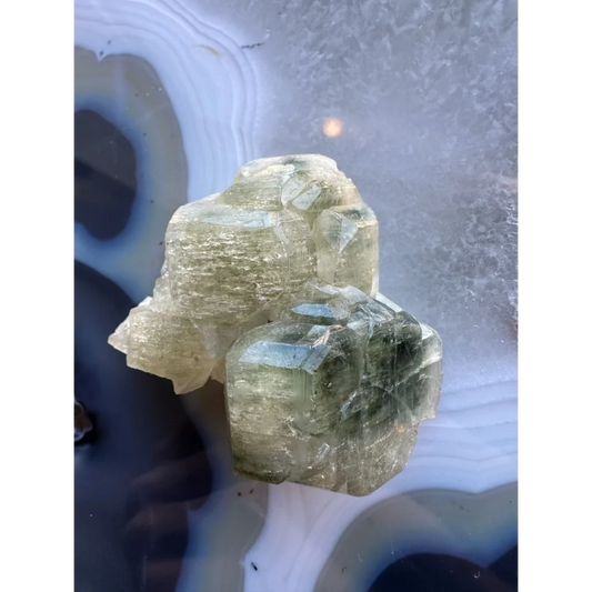 Natural green fluorapatite cluster with translucent crystals and striations