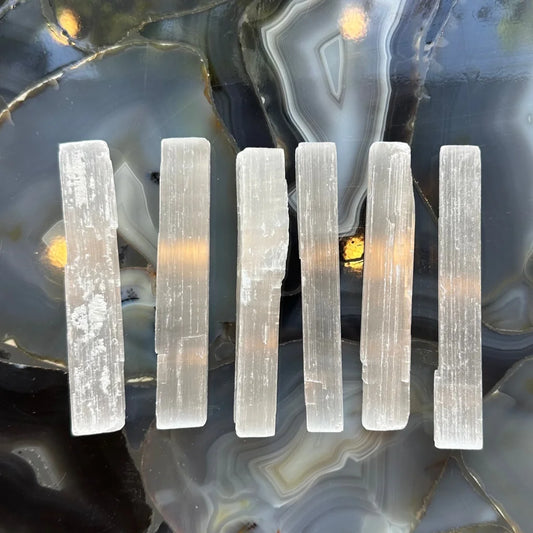Five pale translucent selenite stick crystals from Morocco, 15cm wand