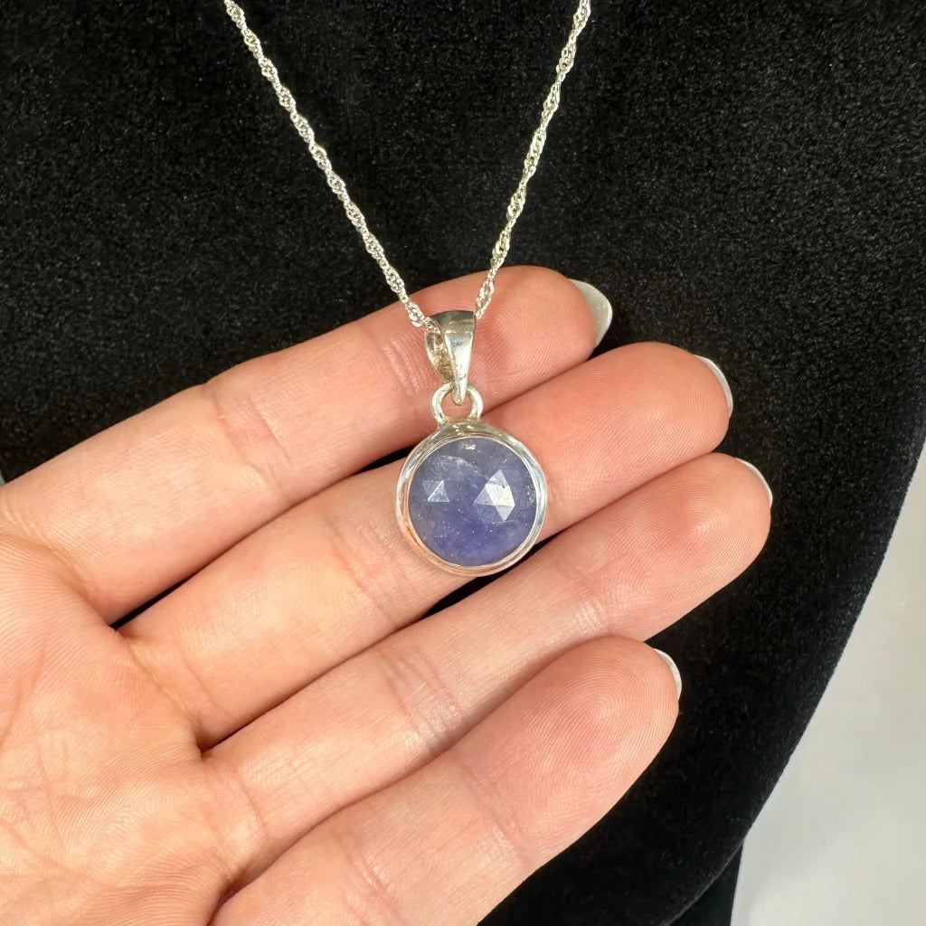 Delicate natural tanzanite pendant in sterling silver bezel setting