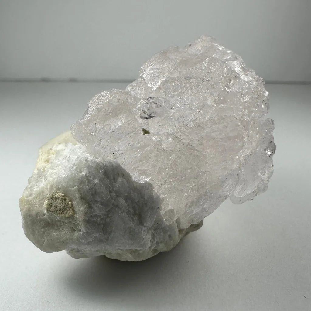 Naturally etched kunzite crystal with quartz inclusions from Brazil