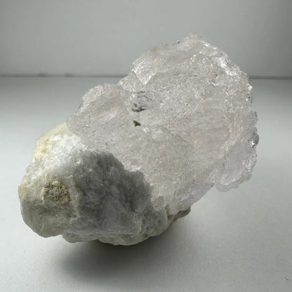 Naturally etched kunzite crystal with quartz inclusions from Brazil