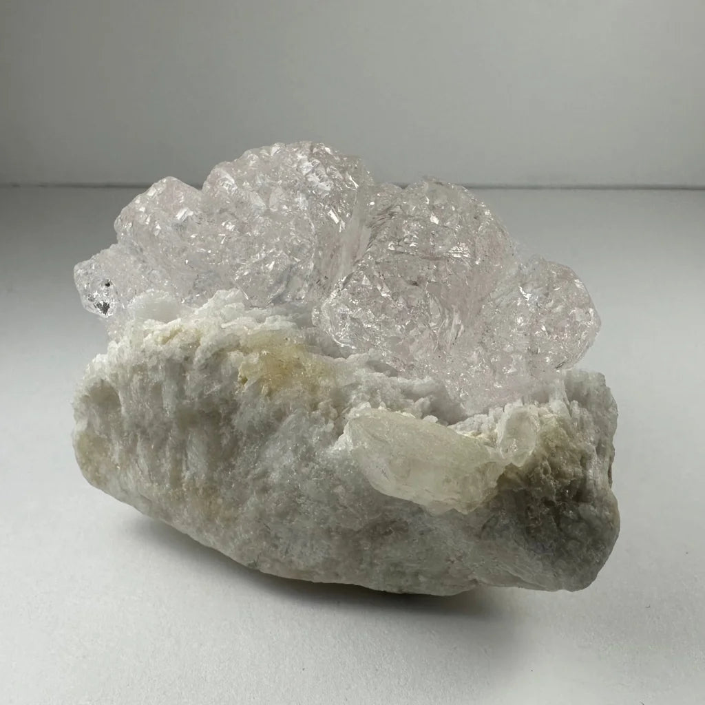 Naturally etched kunzite crystal with translucent quartz facets