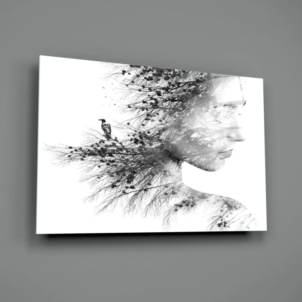 Black-and-white canvas wall art of woman’s profile with tree branches and bird