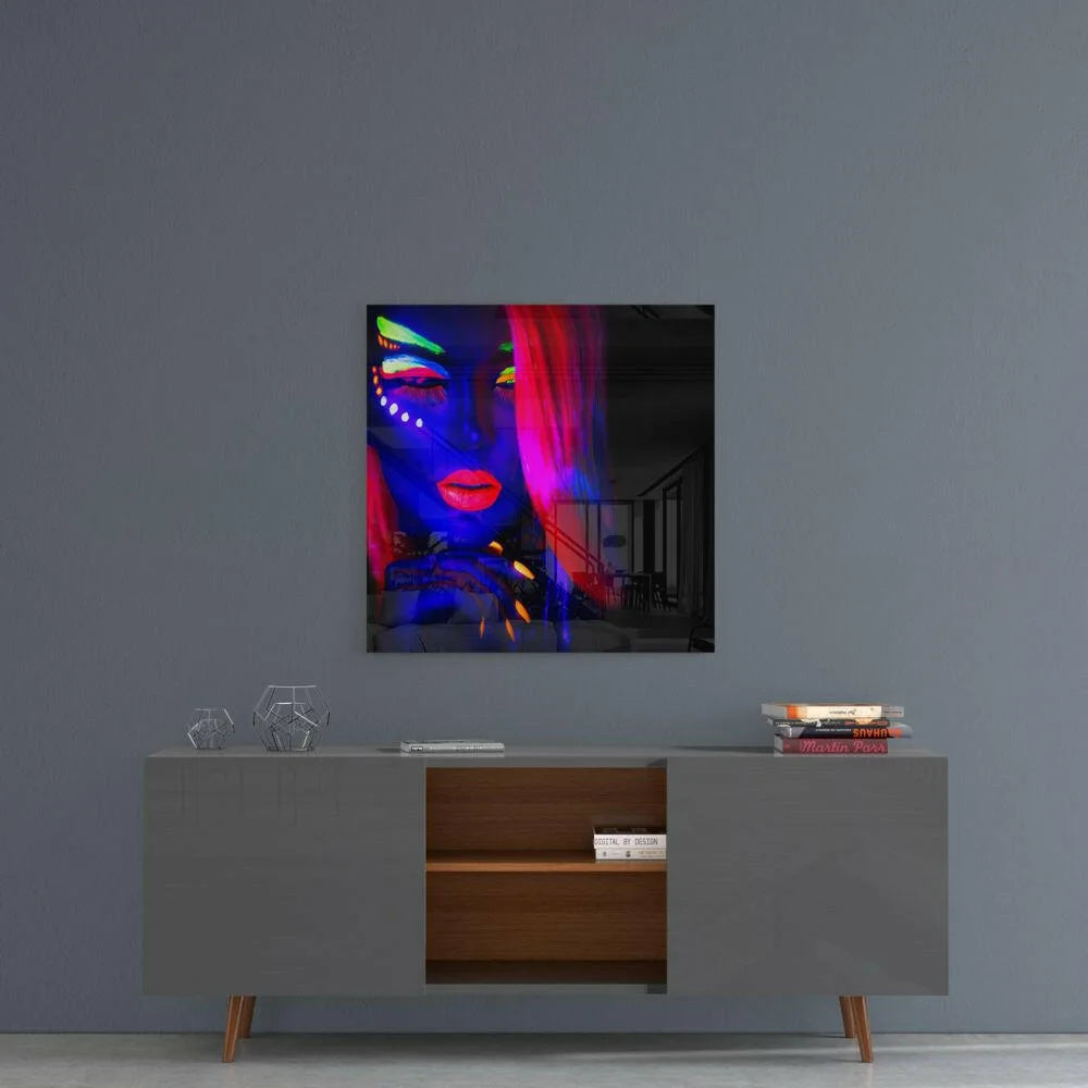 Vibrant neon-lit glass wall art portrait of woman with glowing blue pink green face paint
