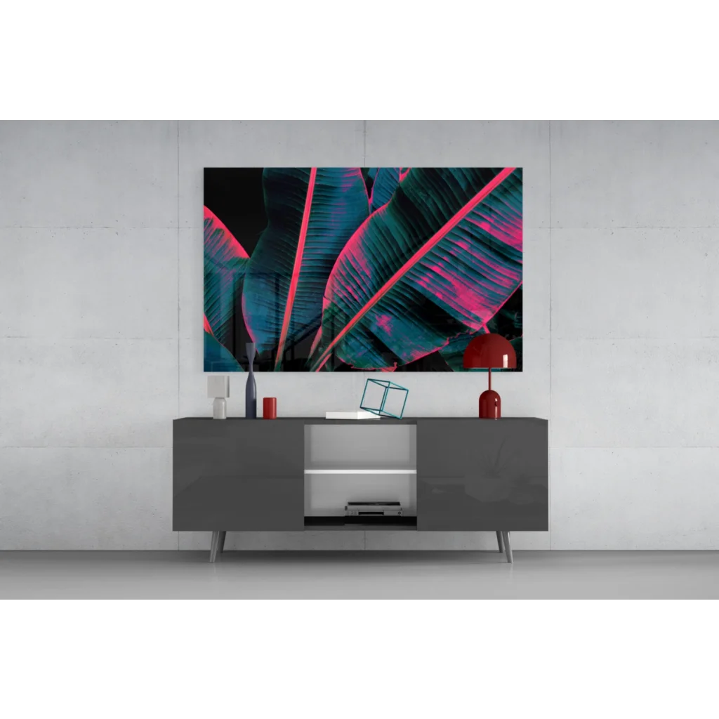 Vibrant neon pink teal banana leaf glass wall art on black background