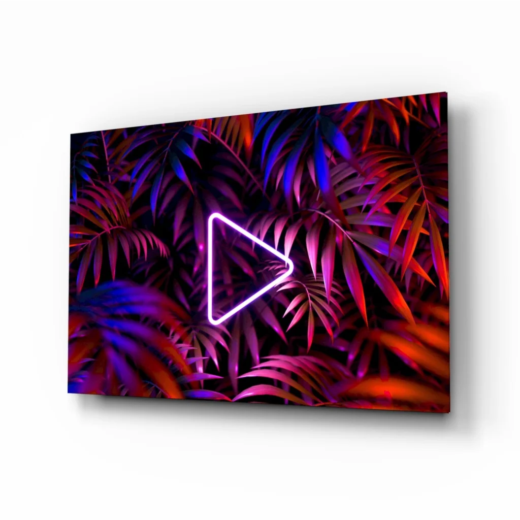 Vibrant neon triangle play button glass wall art on tropical leaves