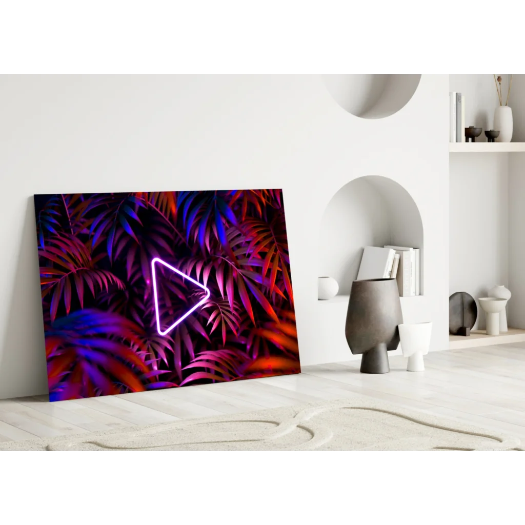 Vibrant neon triangle play button glass wall art on tropical leaves background