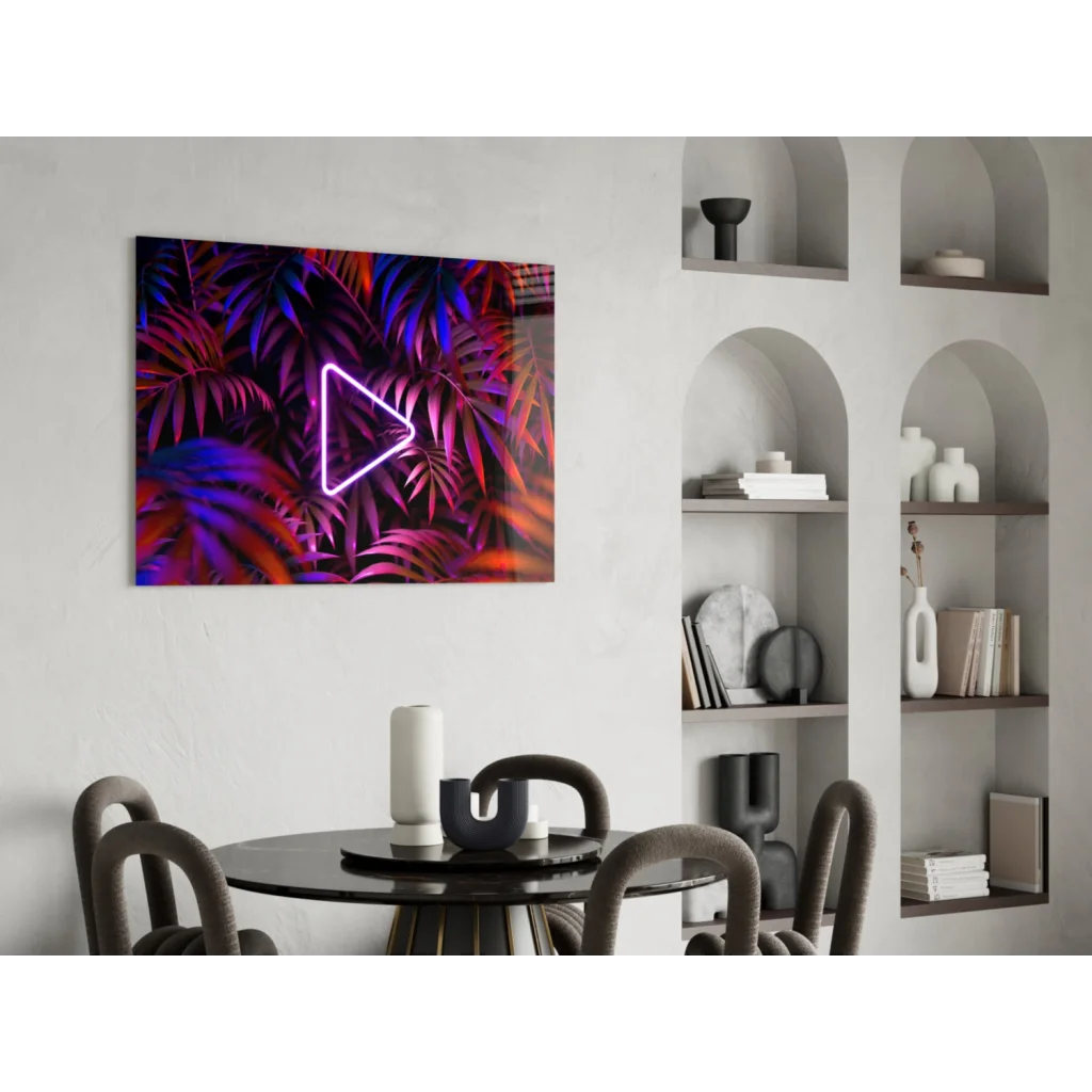 Vibrant neon triangle play button glass wall art on tropical leaves