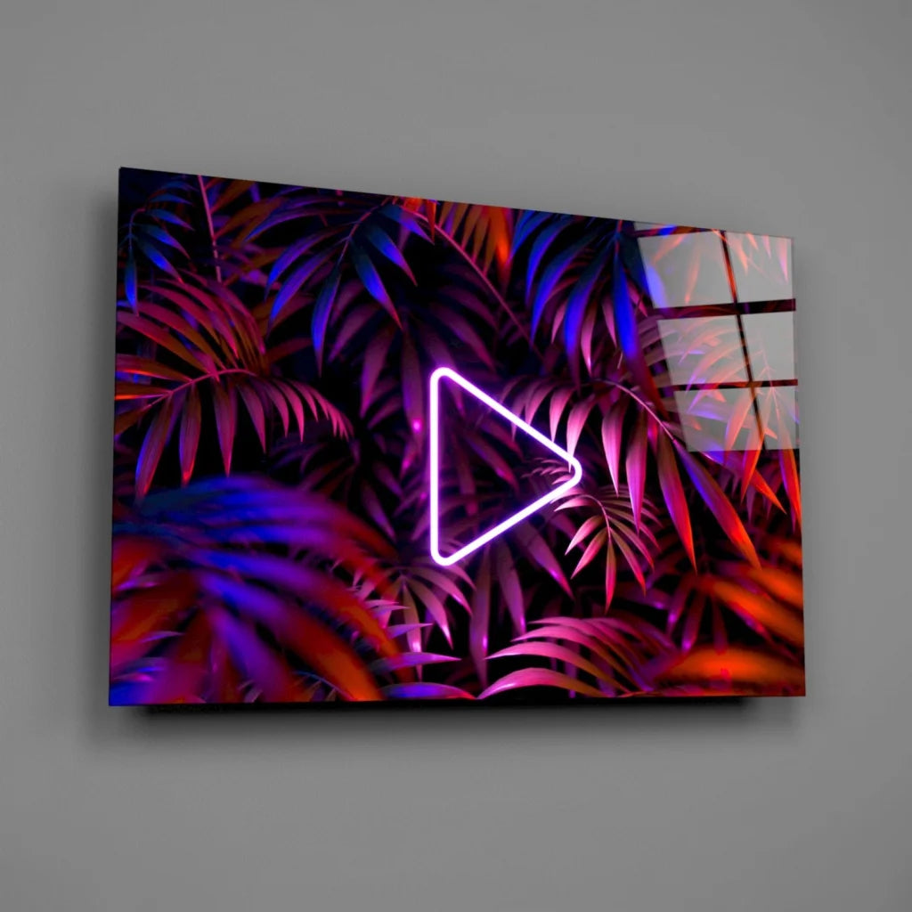 Neon triangle play button glass wall art on tropical leaves