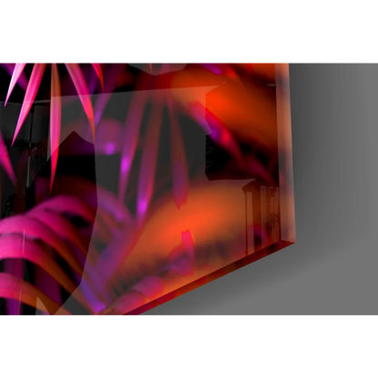 Orange black abstract art print on glass wall art with neon triangle play button on tropical leaves