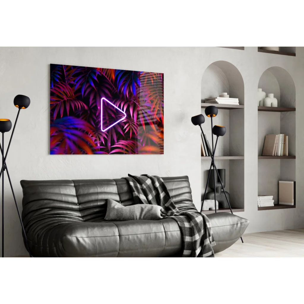 Neon triangle play button wall art on tropical leaves