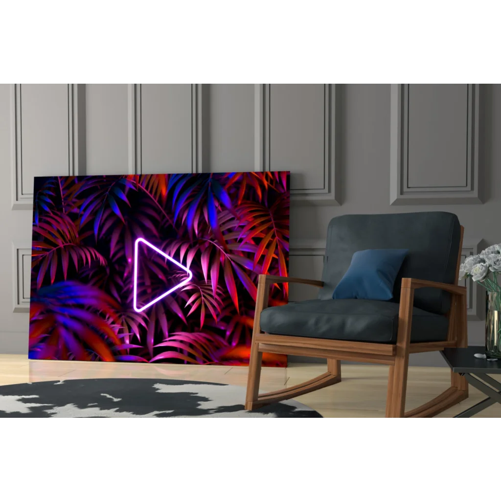 Vibrant neon triangle play button glass wall art on tropical leaves, purple pink hues
