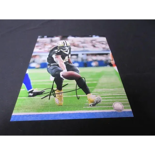 Autographed New Orleans Saints signed 8x10 photo of player in black and gold uniform