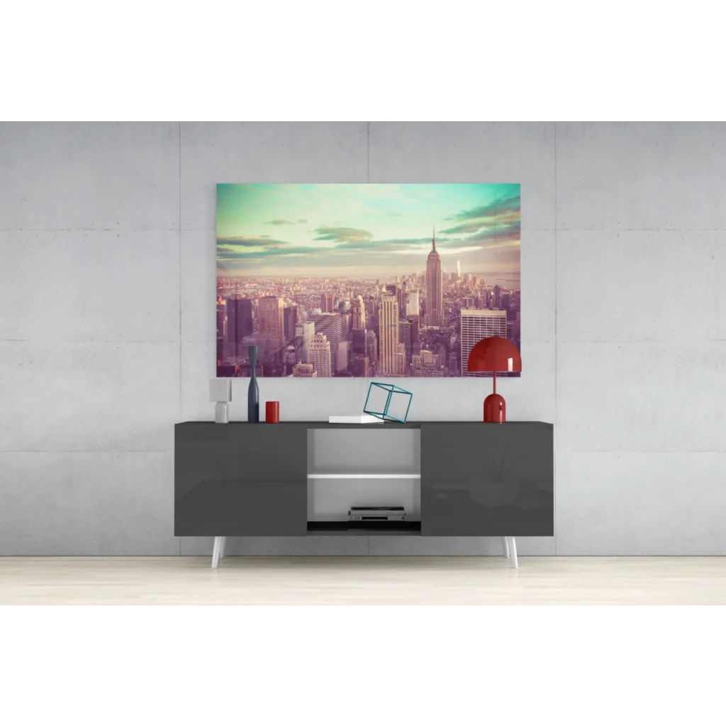 Vibrant Empire State Building glass wall art in pastel sky above gray console