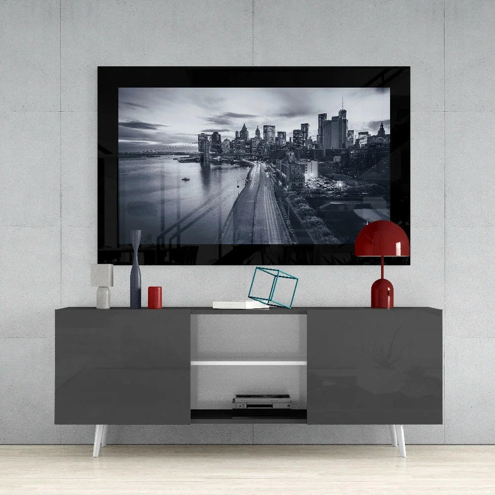 Black-framed TV showing monochrome cityscape glass wall art