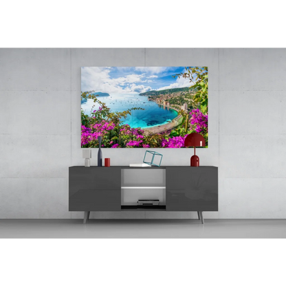 Vibrant glass wall art of coastal landscape with turquoise waters and purple flowers