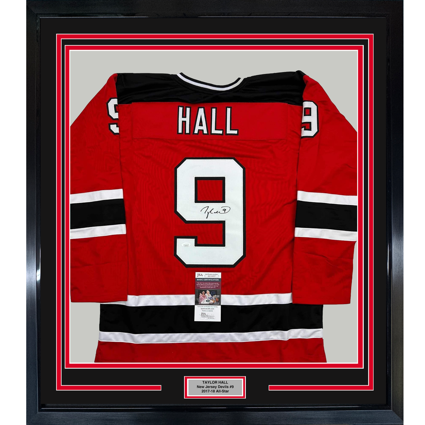 Red New Jersey Devils hockey jersey with "HALL" and number 9 displayed flat in black frame with authentication certificate.