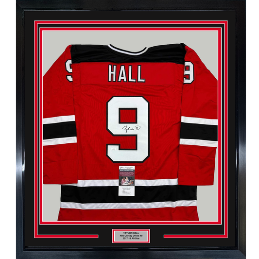 Red New Jersey Devils hockey jersey with "HALL" and number 9 displayed flat in black frame with authentication certificate.