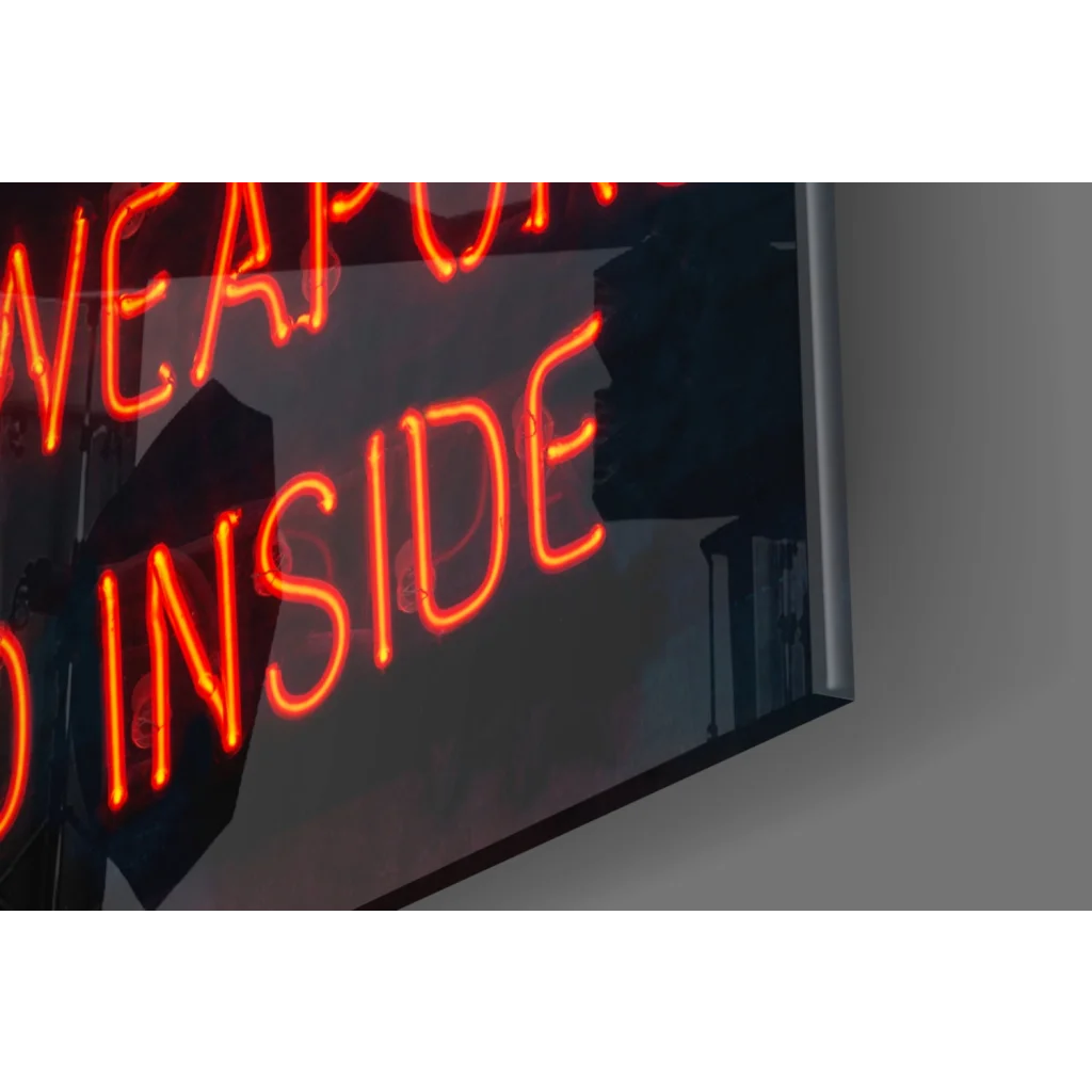 Glowing orange neon Weapons Inside sign on glass wall art