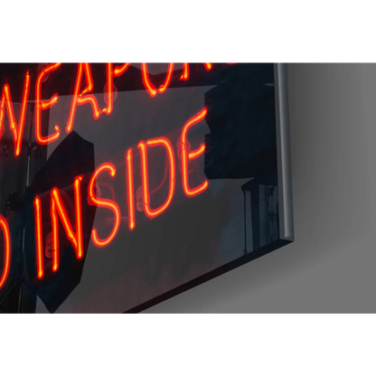 Glowing orange neon Weapons Inside sign on glass wall art
