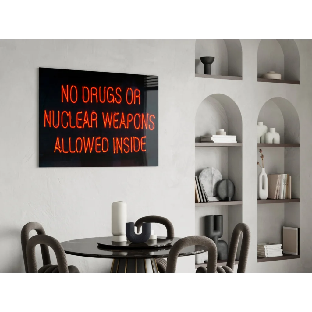 Glowing orange neon glass wall art sign: No drugs or nuclear weapons allowed