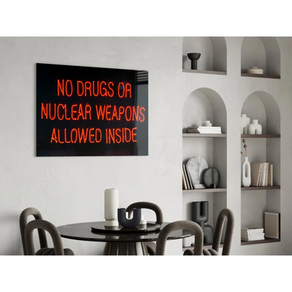 Glowing orange neon glass wall art sign: No drugs or nuclear weapons allowed