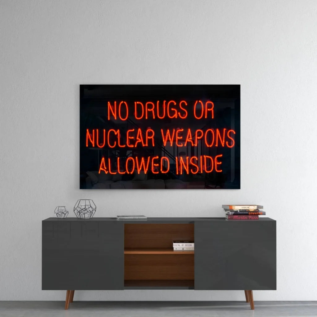 Glowing orange neon glass wall art sign: no drugs or nuclear weapons allowed