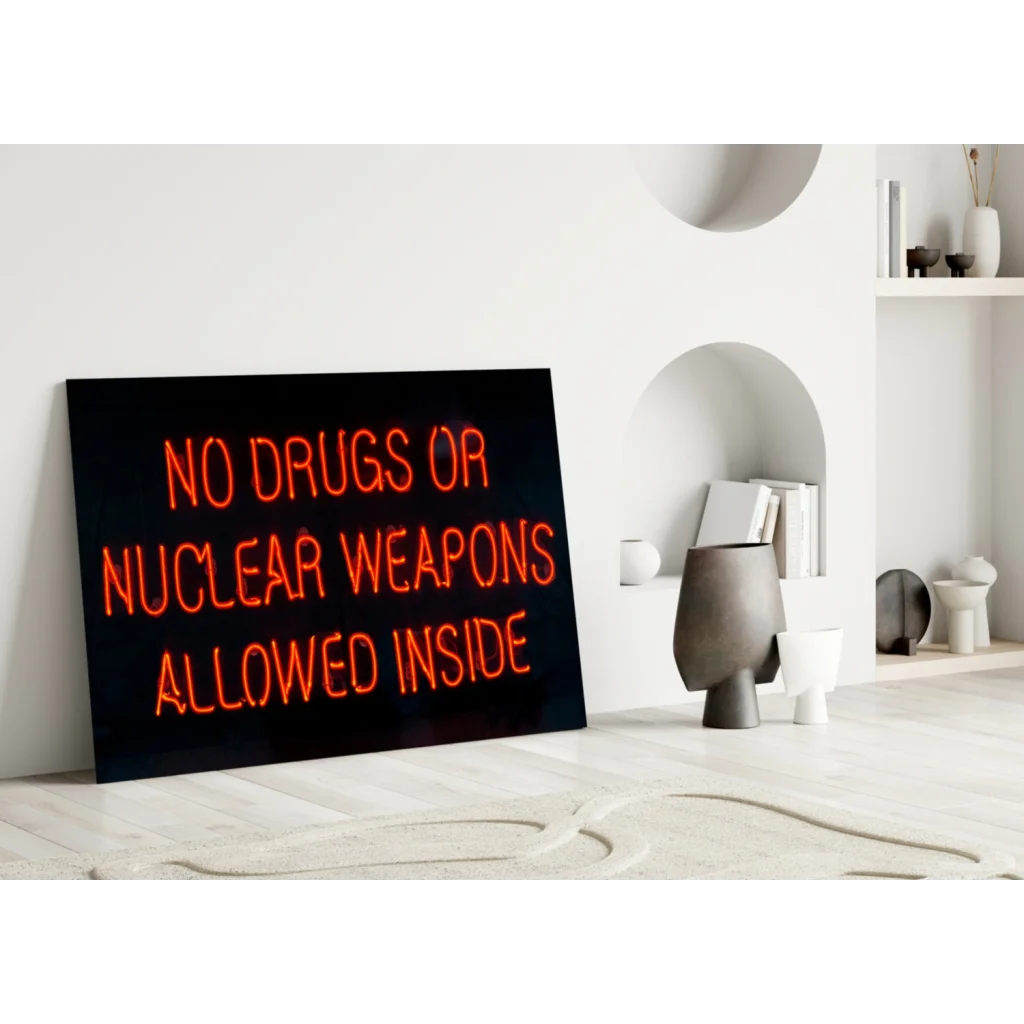 Black rectangular neon glass wall art sign with orange No Drugs or Nuclear Weapons text