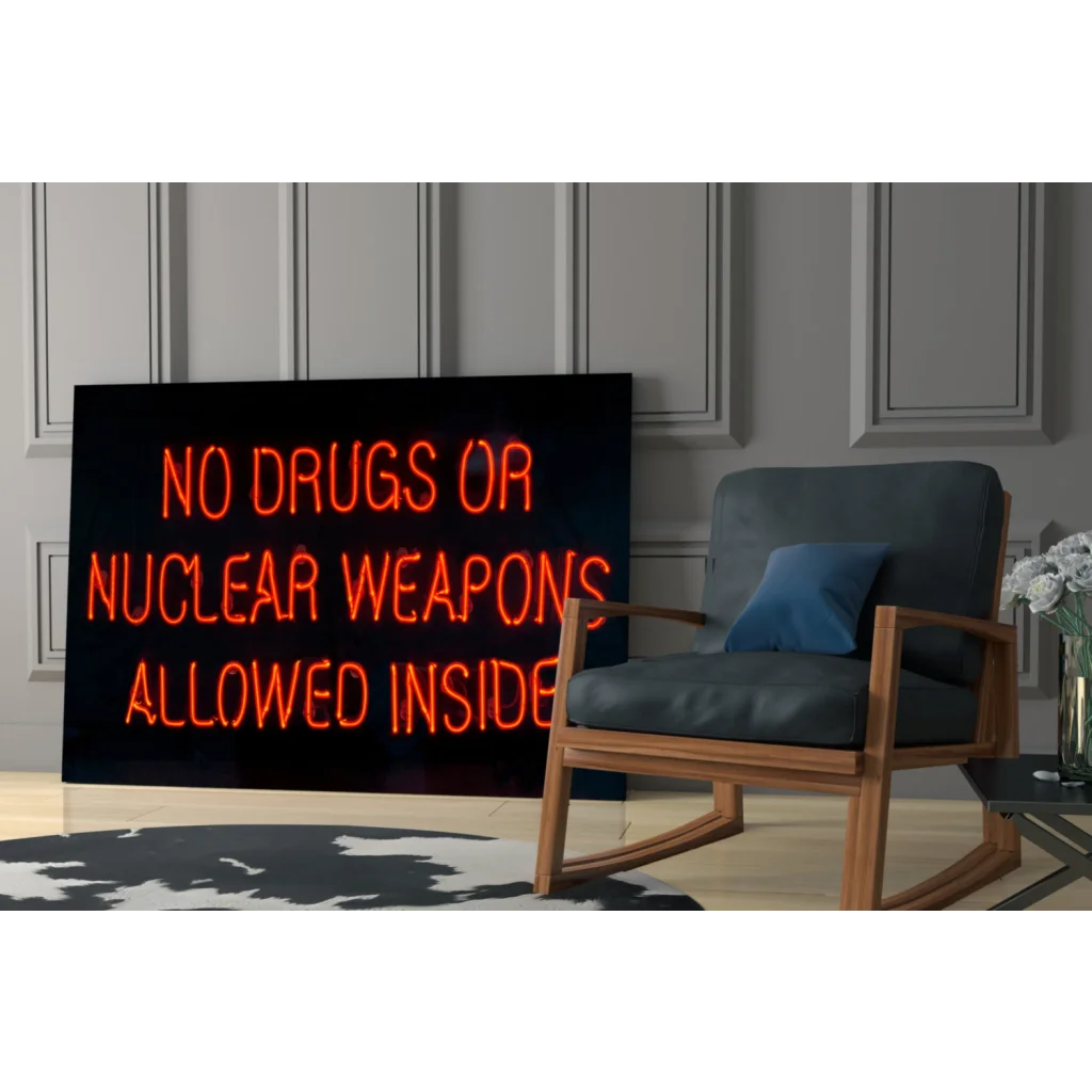 Glowing orange neon no drugs or nuclear weapons sign on glass wall art