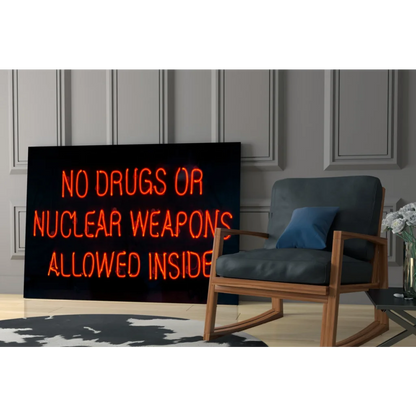 Glowing orange neon no drugs or nuclear weapons sign on glass wall art
