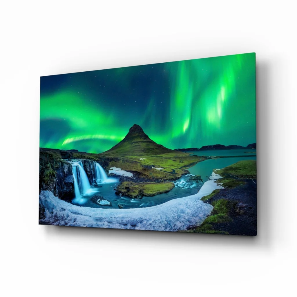 Vibrant green aurora borealis over waterfall and mountain in glass wall art canvas print