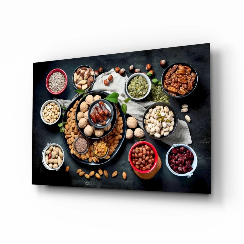Black canvas wall art of nuts and dried fruits in bowls overhead view
