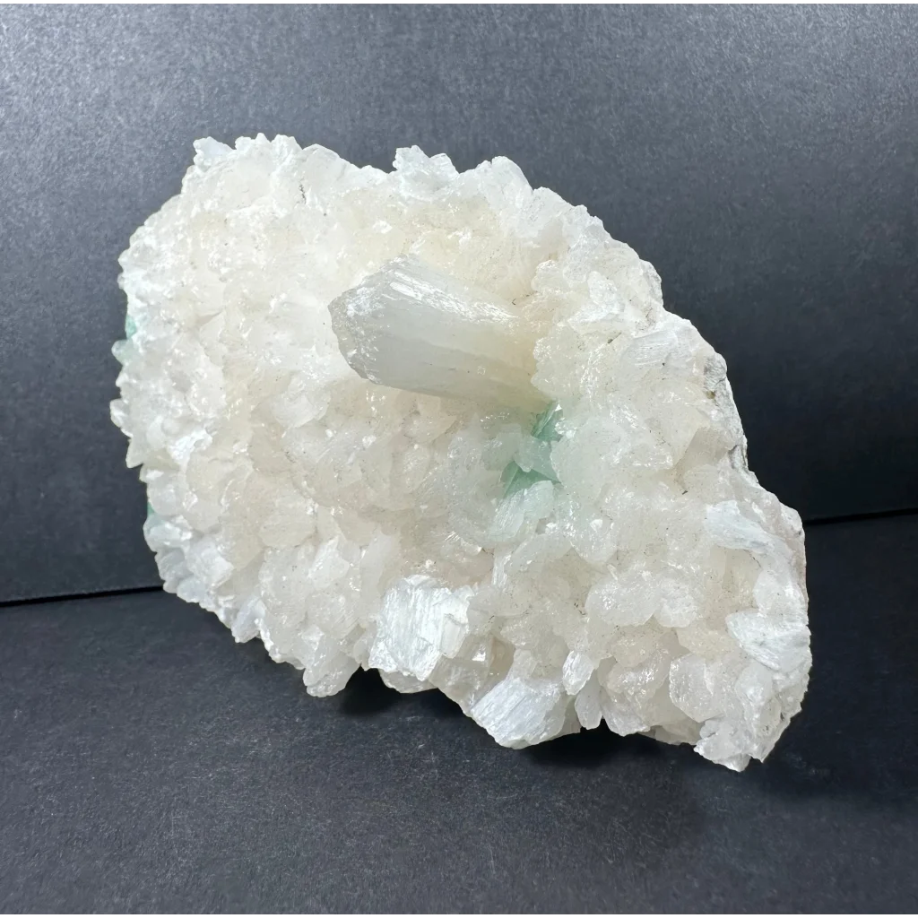 Ocean green apophyllite with stilbite: translucent white crystal cluster and clear quartz point