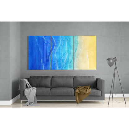 Blue and yellow ocean wave glass wall art triptych with flowing patterns