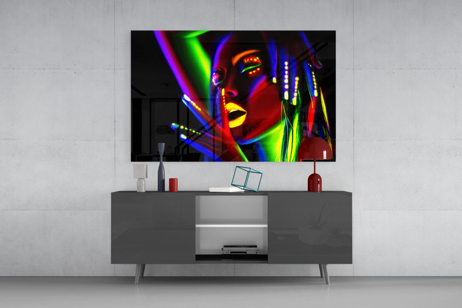Colorful neon portrait glass wall art displayed above gray media console in modern living room setting.