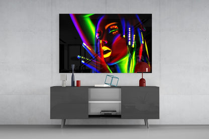 Colorful neon portrait glass wall art displayed above gray media console in modern living room setting.