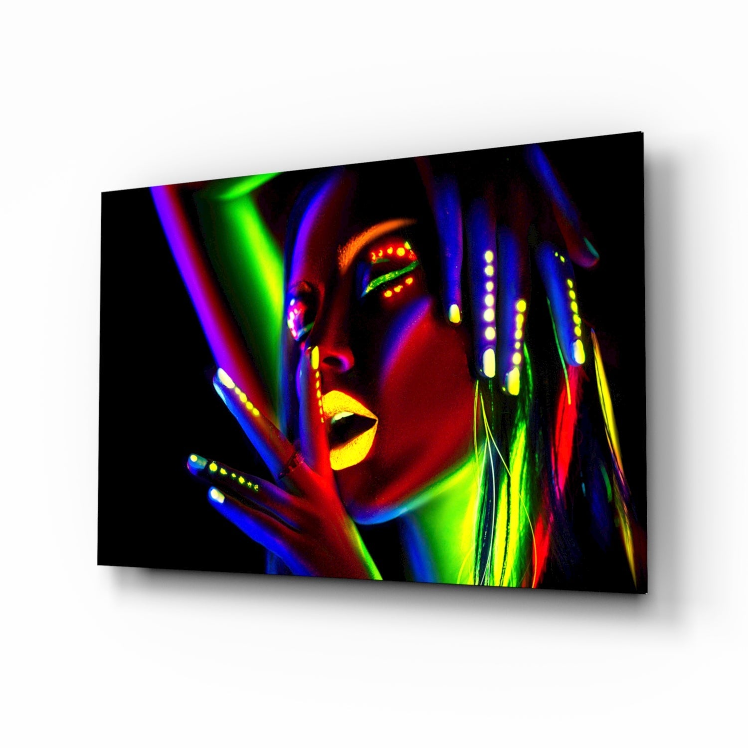 Angled view of glass wall art depicting a colorful neon-style female portrait with bright blue, green, yellow, and red streaks against black background.