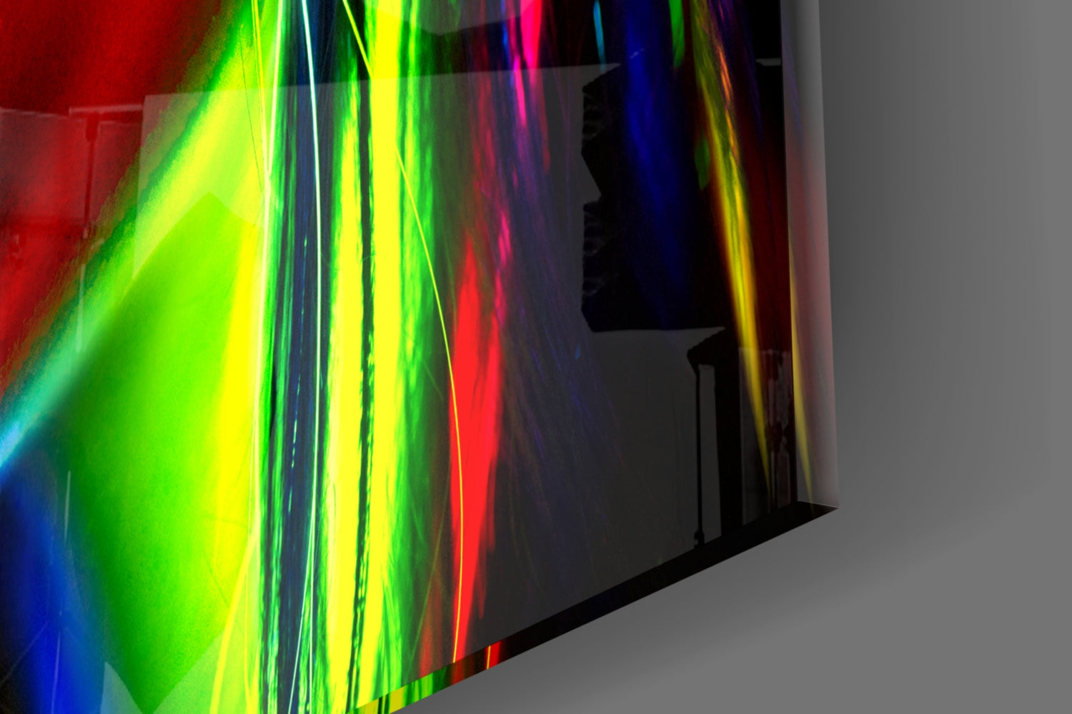 Colorful neon light refracts through tilted glass panel showing female silhouette profile against gray background.