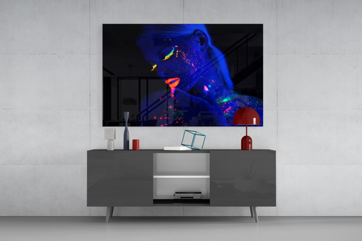Modern living room setup featuring neon-glowing woman portrait glass art displayed above gray media console with red decorative accents.