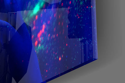Angled side view of glass wall art displaying illuminated red and cyan dots forming a woman's portrait against blue background.