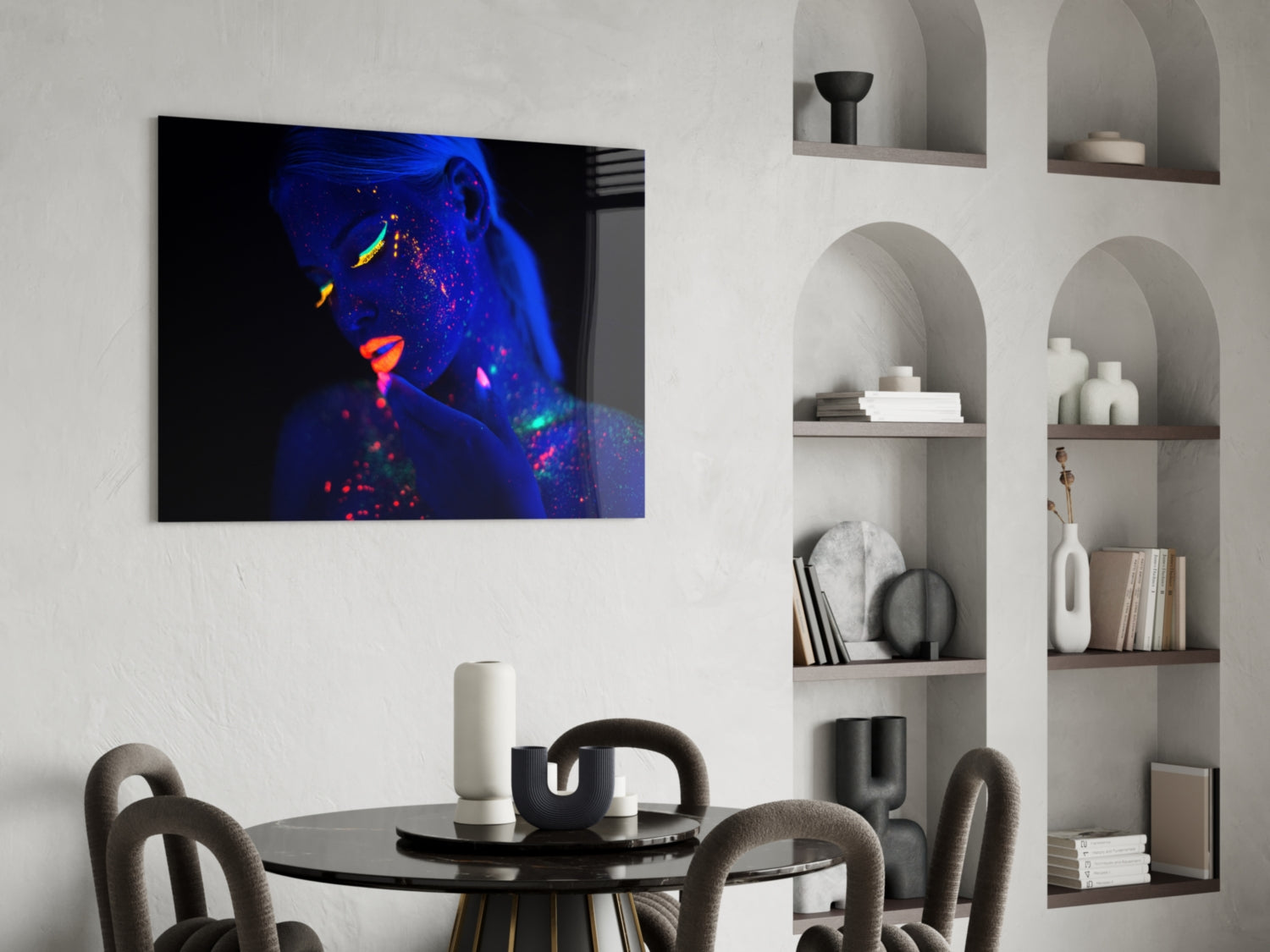 Glass wall art featuring neon-lit woman's portrait with blue, purple, and orange fluorescent colors displayed in modern dining room interior.