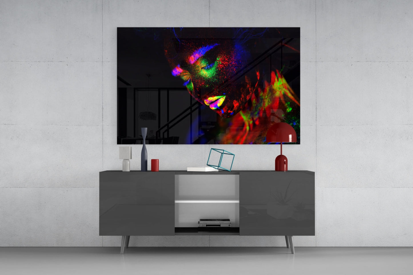 Colorful neon portrait glass art displayed above gray media console in modern living room setting.