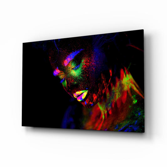 Angled product view of glass wall art displaying colorful neon portrait with vibrant blue, red, green, and yellow pigments on black background.
