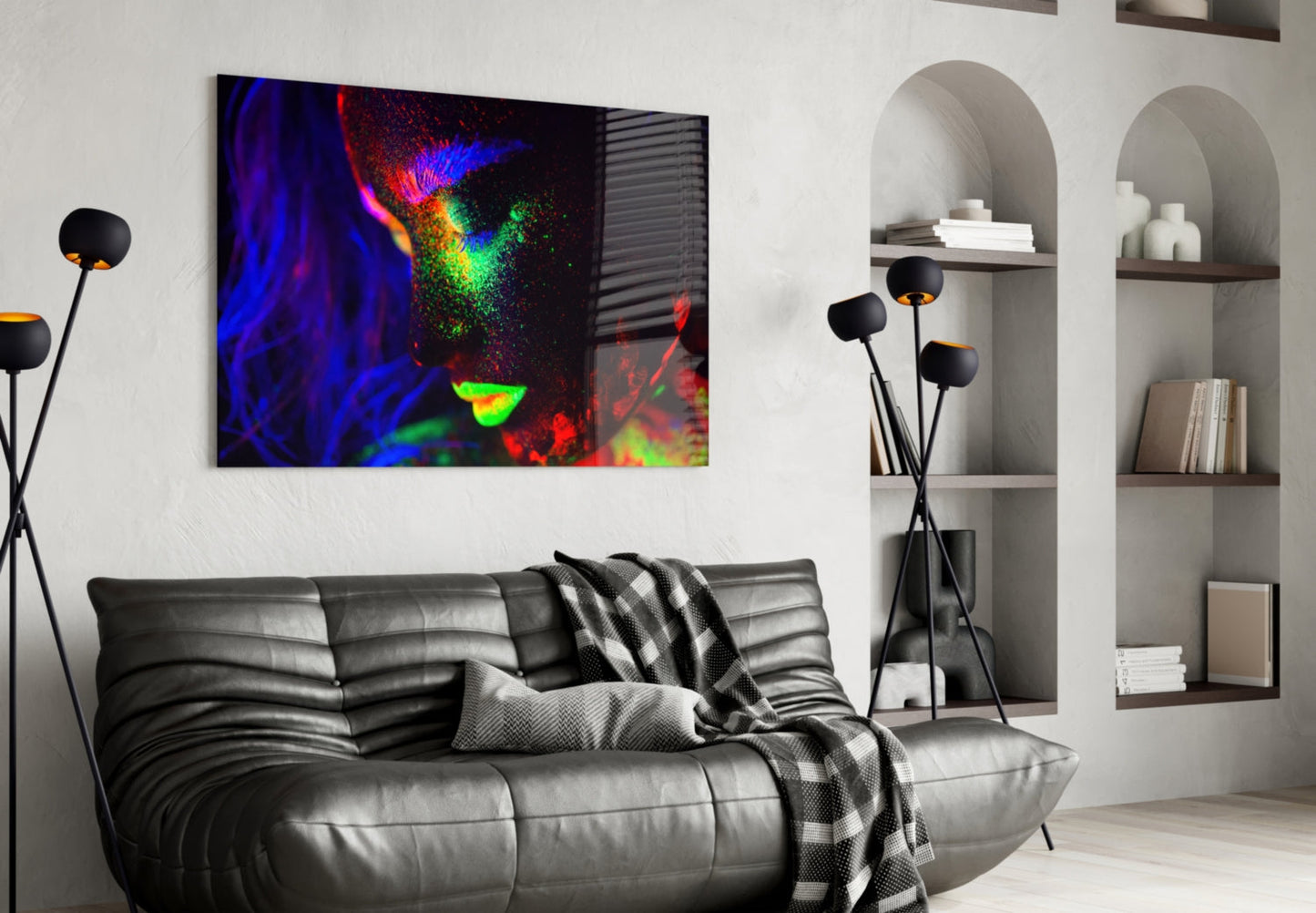 Colorful abstract glass wall art with blue, red, green, and yellow hues displayed above a black leather sofa in a modern living room interior.