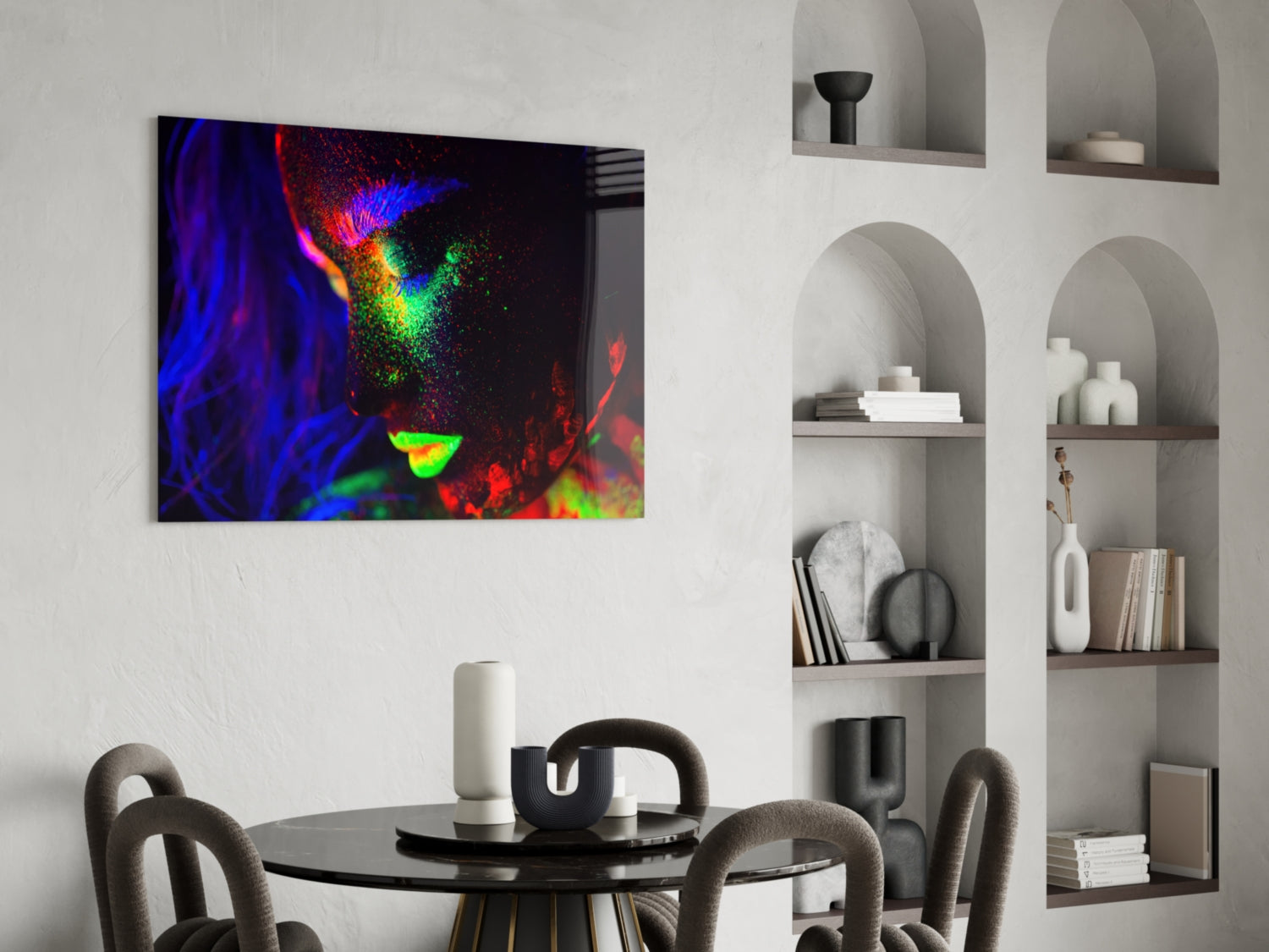 Vibrant neon-colored abstract portrait with blue, red, green, and yellow hues displayed as glass wall art above a modern dining table.