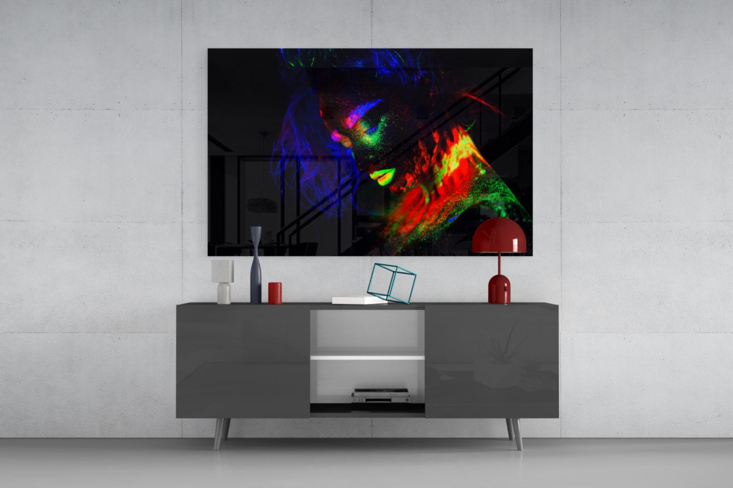 Colorful neon glass wall art depicting a female portrait with vibrant blue, red, green, and yellow hues displayed above a modern gray media console.