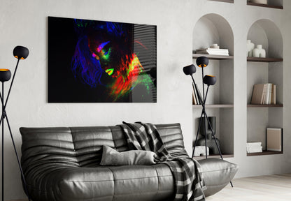 Colorful neon female portrait glass wall art hanging above gray leather sofa in modern living room interior.
